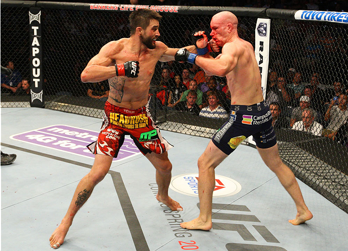 INDIANAPOLIS, IN - AUGUST 28: (L-R) Carlos Condit punches Martin Kampmann in their welterweight fight during the UFC on FOX Sports 1 event at Bankers Life Fieldhouse on August 28, 2013 in Indianapolis, Indiana. (Photo by Ed Mulholland/Zuffa LLC/Zuffa LLC