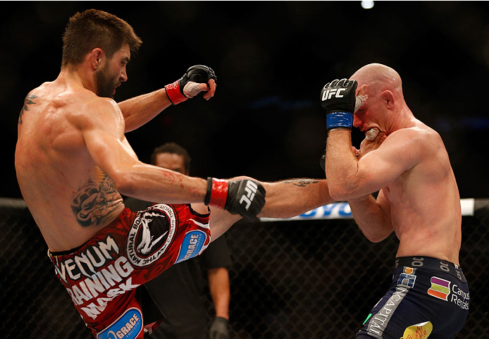 INDIANAPOLIS, IN - AUGUST 28: (L-R) Carlos Condit kicks Martin Kampmann in their welterweight fight during the UFC on FOX Sports 1 event at Bankers Life Fieldhouse on August 28, 2013 in Indianapolis, Indiana. (Photo by Josh Hedges/Zuffa LLC/Zuffa LLC via