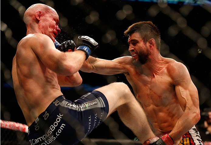 INDIANAPOLIS, IN - AUGUST 28: (R-L) Carlos Condit punches Martin Kampmann in their welterweight fight during the UFC on FOX Sports 1 event at Bankers Life Fieldhouse on August 28, 2013 in Indianapolis, Indiana. (Photo by Josh Hedges/Zuffa LLC/Zuffa LLC v
