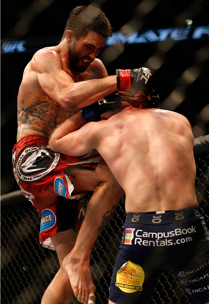 INDIANAPOLIS, IN - AUGUST 28: (L-R) Carlos Condit knees Martin Kampmann in their welterweight fight during the UFC on FOX Sports 1 event at Bankers Life Fieldhouse on August 28, 2013 in Indianapolis, Indiana. (Photo by Josh Hedges/Zuffa LLC/Zuffa LLC via