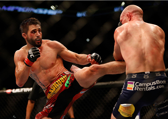 INDIANAPOLIS, IN - AUGUST 28: (L-R) Carlos Condit punches Martin Kampmann in their welterweight fight during the UFC on FOX Sports 1 event at Bankers Life Fieldhouse on August 28, 2013 in Indianapolis, Indiana. (Photo by Josh Hedges/Zuffa LLC/Zuffa LLC v