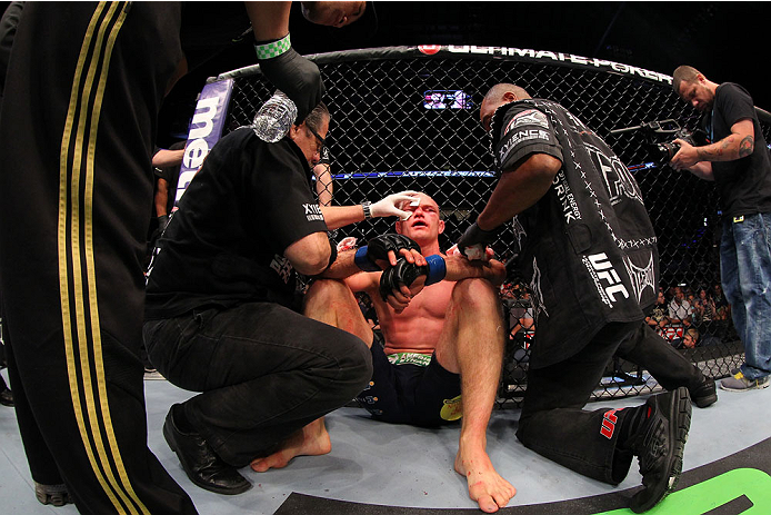 INDIANAPOLIS, IN - AUGUST 28: Martin Kampmann is treated by cut men after his TKO loss to Carlos Condit in their welterweight fight during the UFC on FOX Sports 1 event at Bankers Life Fieldhouse on August 28, 2013 in Indianapolis, Indiana. (Photo by Ed