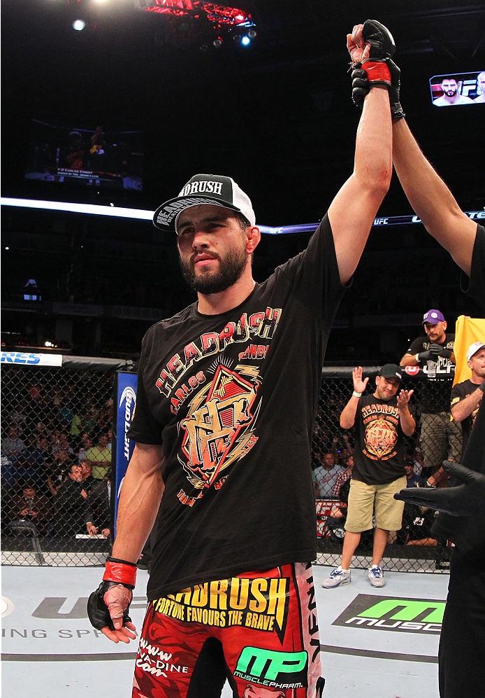 INDIANAPOLIS, IN - AUGUST 28: Carlos Condit reacts after his TKO victory over Martin Kampmann in their welterweight fight during the UFC on FOX Sports 1 event at Bankers Life Fieldhouse on August 28, 2013 in Indianapolis, Indiana. (Photo by Ed Mulholland