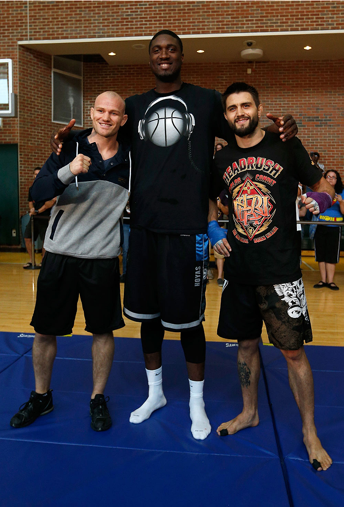 INDIANAPOLIS, IN - AUGUST 26: Opponents Martin Kampmann (L) and Carlos Condit (R) pose for photos with Indiana Pacers center Roy Hibbert at Banker's Life Fieldhouse on August 26, 2013 in Indianapolis, Indiana. (Photo by Josh Hedges/Zuffa LLC/Zuffa LLC vi