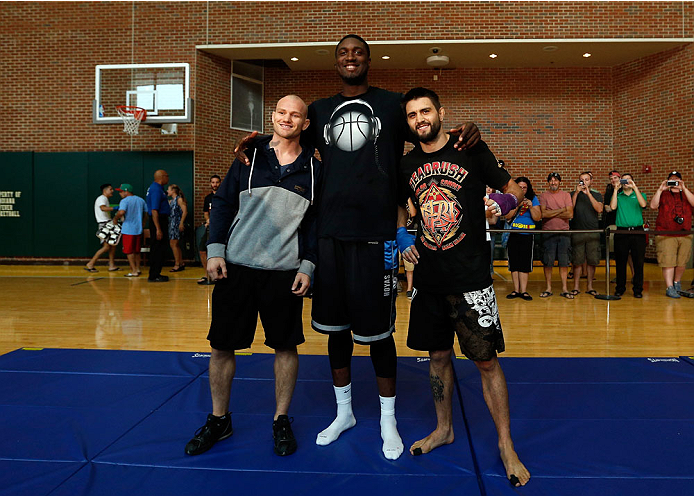 INDIANAPOLIS, IN - AUGUST 26: Opponents Martin Kampmann (L) and Carlos Condit (R) pose for photos with Indiana Pacers center Roy Hibbert at Banker's Life Fieldhouse on August 26, 2013 in Indianapolis, Indiana. (Photo by Josh Hedges/Zuffa LLC/Zuffa LLC vi
