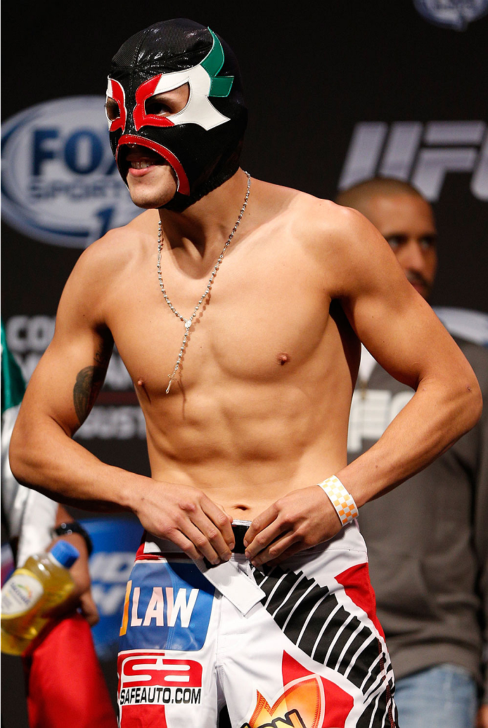 INDIANAPOLIS, IN - AUGUST 27: Erik Perez prepares to step on the scale during UFC weigh-in event at Bankers Life Fieldhouse on August 27, 2013 in Indianapolis, Indiana. (Photo by Josh Hedges/Zuffa LLC/Zuffa LLC via Getty Images)