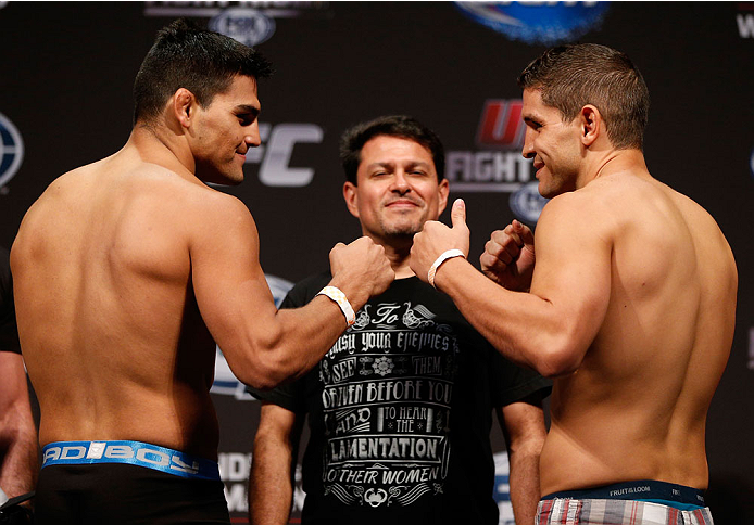 INDIANAPOLIS, IN - AUGUST 27: (L-R) Opponents Kelvin Gastelum and Brian Melancon face off during the UFC weigh-in event at Bankers Life Fieldhouse on August 27, 2013 in Indianapolis, Indiana. (Photo by Josh Hedges/Zuffa LLC/Zuffa LLC via Getty Images)