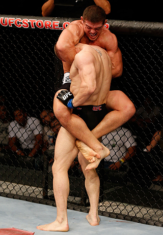 FORTALEZA, BRAZIL - JUNE 08: Caio Magalhaes (top) attempts a guillotine choke against Karlos Vemola in their middleweight fight during the UFC on FUEL TV event at Paulo Sarasate Arena on June 8, 2013 in Fortaleza, Ceara, Brazil. (Photo by Josh Hedges/Zu