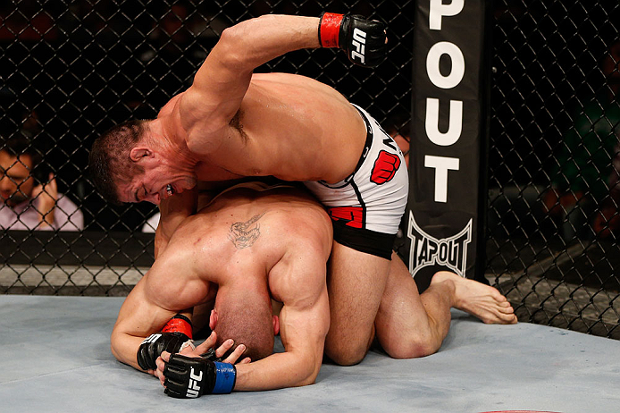 FORTALEZA, BRAZIL - JUNE 08: Caio Magalhaes (top) punches Karlos Vemola in their middleweight fight during the UFC on FUEL TV event at Paulo Sarasate Arena on June 8, 2013 in Fortaleza, Ceara, Brazil. (Photo by Josh Hedges/Zuffa LLC/Zuffa LLC via Getty