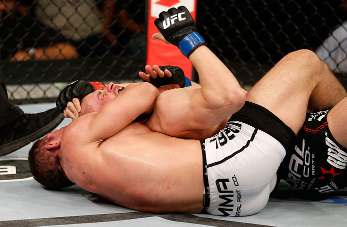 FORTALEZA, BRAZIL - JUNE 08: (L-R) Caio Magalhaes secures a rear choke submission against Karlos Vemola in their middleweight fight during the UFC on FUEL TV event at Paulo Sarasate Arena on June 8, 2013 in Fortaleza, Ceara, Brazil. (Photo by Josh Hedge