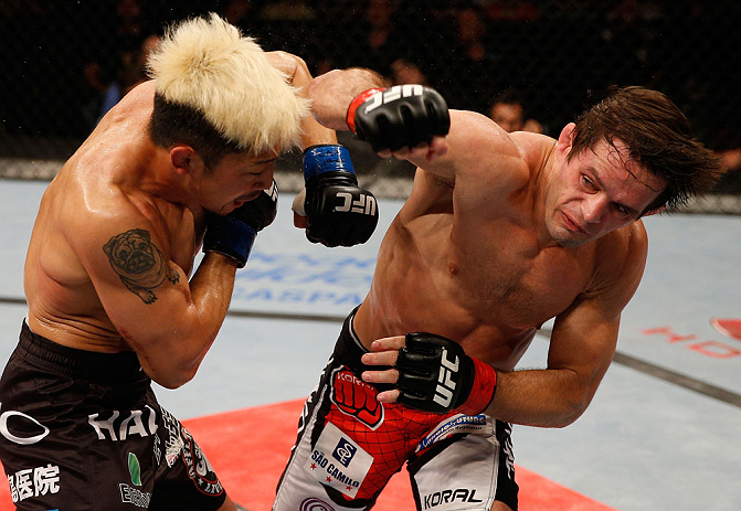 FORTALEZA, BRAZIL - JUNE 08: (R-L) Rodrigo Damm punches Mizuto Hirota in their featherweight fight during the UFC on FUEL TV event at Paulo Sarasate Arena on June 8, 2013 in Fortaleza, Ceara, Brazil. (Photo by Josh Hedges/Zuffa LLC/Zuffa LLC via Getty I