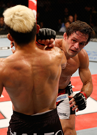 FORTALEZA, BRAZIL - JUNE 08: (R-L) Rodrigo Damm punches Mizuto Hirota in their featherweight fight during the UFC on FUEL TV event at Paulo Sarasate Arena on June 8, 2013 in Fortaleza, Ceara, Brazil. (Photo by Josh Hedges/Zuffa LLC/Zuffa LLC via Getty I