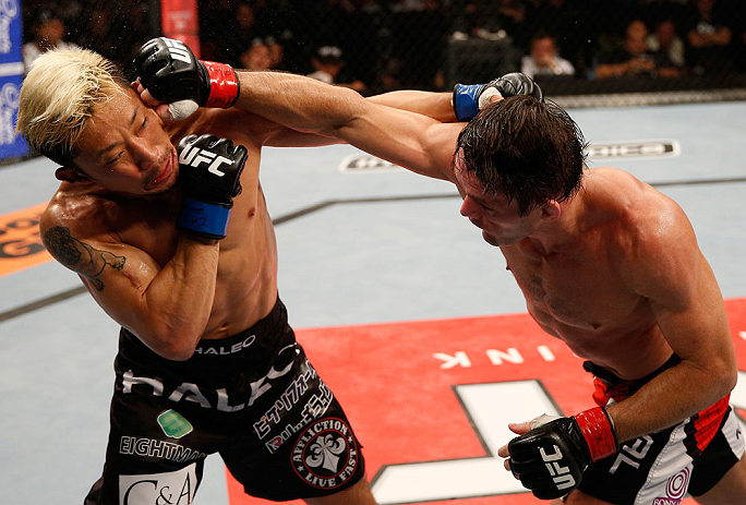 FORTALEZA, BRAZIL - JUNE 08: (R-L) Rodrigo Damm punches Mizuto Hirota in their featherweight fight during the UFC on FUEL TV event at Paulo Sarasate Arena on June 8, 2013 in Fortaleza, Ceara, Brazil. (Photo by Josh Hedges/Zuffa LLC/Zuffa LLC via Getty I