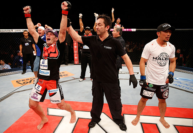 FORTALEZA, BRAZIL - JUNE 08: Rodrigo Damm (L) reacts after his split decision victory over Mizuto Hirota in their featherweight fight during the UFC on FUEL TV event at Paulo Sarasate Arena on June 8, 2013 in Fortaleza, Ceara, Brazil. (Photo by Josh Hed