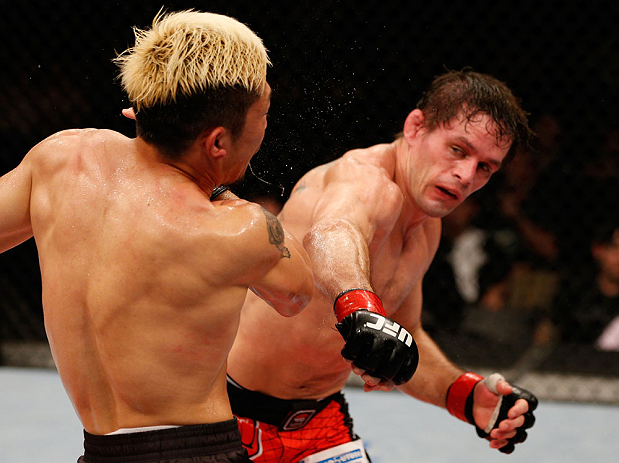 FORTALEZA, BRAZIL - JUNE 08: (R-L) Rodrigo Damm punches Mizuto Hirota in their featherweight fight during the UFC on FUEL TV event at Paulo Sarasate Arena on June 8, 2013 in Fortaleza, Ceara, Brazil. (Photo by Josh Hedges/Zuffa LLC/Zuffa LLC via Getty I