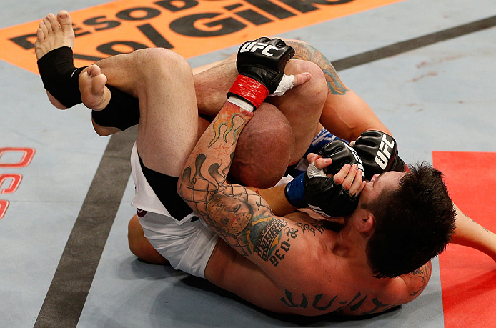FORTALEZA, BRAZIL - JUNE 08: (R-L) Rony "Jason" Mariano Bezerra secures a triangle choke submission against Mike Wilkinson in their featherweight fight during the UFC on FUEL TV event at Paulo Sarasate Arena on June 8, 2013 in Fortaleza, Ceara, Brazil.