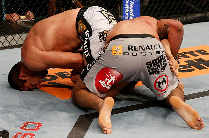 FORTALEZA, BRAZIL - JUNE 08: (L-R) Fabricio Werdum secures an arm bar submission against Antonio Rodrigo "Minotauro" Nogueira in their heavyweight fight during the UFC on FUEL TV event at Paulo Sarasate Arena on June 8, 2013 in Fortaleza, Ceara, Brazil.