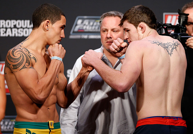 GOLD COAST, AUSTRALIA - DECEMBER 14: (L-R) Opponents Robert Whittaker and Bradley Scott face off during the UFC on FX weigh in on December 14, 2012 at Gold Coast Convention and Exhibition Centre in Gold Coast, Queensland, Australia. (Photo by Josh Hedge