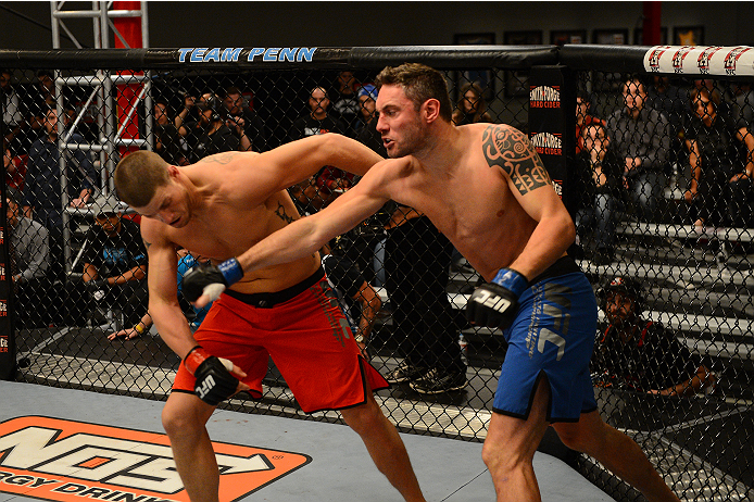 LAS VEGAS, NV - OCTOBER 16: (R-L) Chris Fields punches Josh Stansbury in their elimination fight during filming of season nineteen of The Ultimate Fighter on October 16, 2013 in Las Vegas, Nevada. (Photo by Al Powers/Zuffa LLC/Zuffa LLC via Getty Images)