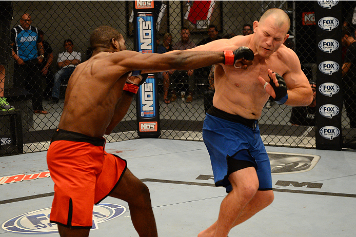 LAS VEGAS, NV - OCTOBER 16: (L-R) Corey Anderson punches Kelly Anundson in their elimination fight during filming of season nineteen of The Ultimate Fighter on October 16, 2013 in Las Vegas, Nevada. (Photo by Al Powers/Zuffa LLC/Zuffa LLC via Getty Image