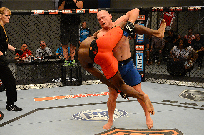 LAS VEGAS, NV - OCTOBER 16: (R-L) Kelly Anundson takes down Corey Anderson in their elimination fight during filming of season nineteen of The Ultimate Fighter on October 16, 2013 in Las Vegas, Nevada. (Photo by Al Powers/Zuffa LLC/Zuffa LLC via Getty Im