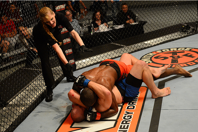 LAS VEGAS, NV - OCTOBER 16: Kelly Anundson (blue shorts) is submitted by Corey Anderson in their elimination fight during filming of season nineteen of The Ultimate Fighter on October 16, 2013 in Las Vegas, Nevada. (Photo by Al Powers/Zuffa LLC/Zuffa LLC