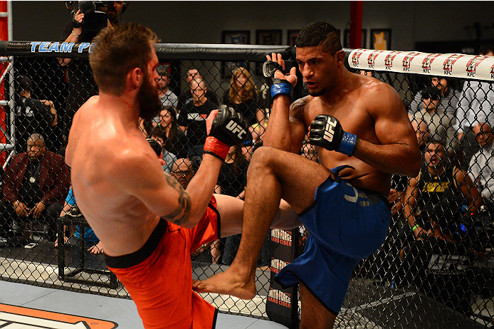 LAS VEGAS, NV - OCTOBER 16: (R-L) Dhiego Lima blocks a kick from Adam Stroup in their elimination fight during filming of season nineteen of The Ultimate Fighter on October 16, 2013 in Las Vegas, Nevada. (Photo by Al Powers/Zuffa LLC/Zuffa LLC via Getty