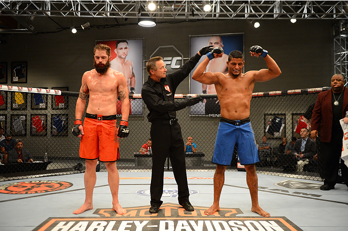LAS VEGAS, NV - OCTOBER 16: (R-L) Dhiego Lima celebrates after defeating Adam Stroup in their elimination fight during filming of season nineteen of The Ultimate Fighter on October 16, 2013 in Las Vegas, Nevada. (Photo by Al Powers/Zuffa LLC/Zuffa LLC vi