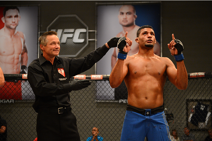 LAS VEGAS, NV - OCTOBER 16: (R-L) Dhiego Lima celebrates after defeating Adam Stroup in their elimination fight during filming of season nineteen of The Ultimate Fighter on October 16, 2013 in Las Vegas, Nevada. (Photo by Al Powers/Zuffa LLC/Zuffa LLC vi