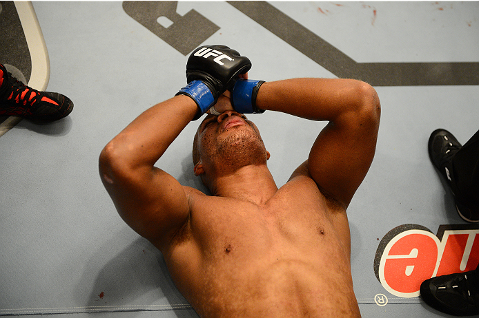 LAS VEGAS, NV - OCTOBER 16: Adrian Miles rests on the floor after being defeated by Hector Urbina in their elimination fight during filming of season nineteen of The Ultimate Fighter on October 16, 2013 in Las Vegas, Nevada. (Photo by Al Powers/Zuffa LLC