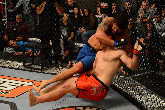 LAS VEGAS, NV - OCTOBER 16: (L-R) Josh Clark takes down John Poppie in their elimination fight during filming of season nineteen of The Ultimate Fighter on October 16, 2013 in Las Vegas, Nevada. (Photo by Al Powers/Zuffa LLC/Zuffa LLC via Getty Images) *
