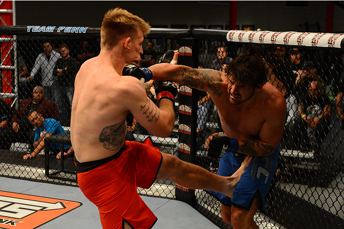 LAS VEGAS, NV - OCTOBER 16: (R-L) Josh Clark punches John Poppie in their elimination fight during filming of season nineteen of The Ultimate Fighter on October 16, 2013 in Las Vegas, Nevada. (Photo by Al Powers/Zuffa LLC/Zuffa LLC via Getty Images) ***