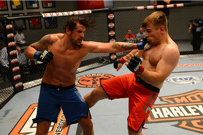 LAS VEGAS, NV - OCTOBER 16: (L-R) Josh Clark punches John Poppie in their elimination fight during filming of season nineteen of The Ultimate Fighter on October 16, 2013 in Las Vegas, Nevada. (Photo by Al Powers/Zuffa LLC/Zuffa LLC via Getty Images) ***