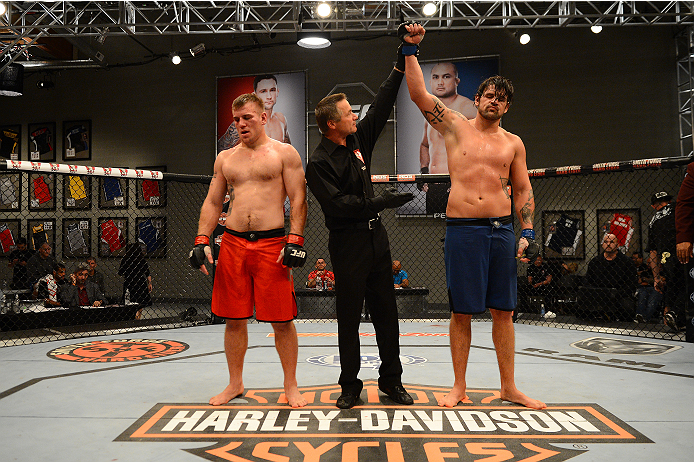 LAS VEGAS, NV - OCTOBER 16: (R-L) Josh Clark celebrates after defeating John Poppie in their elimination fight during filming of season nineteen of The Ultimate Fighter on October 16, 2013 in Las Vegas, Nevada. (Photo by Al Powers/Zuffa LLC/Zuffa LLC via