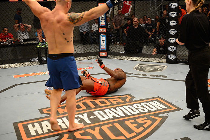 LAS VEGAS, NV - OCTOBER 16: (L-R) Jake Helin celebrates early as Todd Monaghan falls to the mat in their elimination fight during filming of season nineteen of The Ultimate Fighter on October 16, 2013 in Las Vegas, Nevada. (Photo by Al Powers/Zuffa LLC/Z