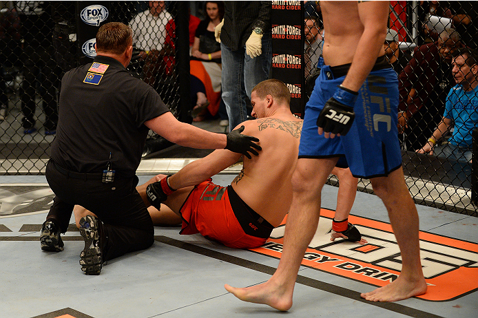 LAS VEGAS, NV - OCTOBER 16: (L-R) Josh Stansbury blows out his knee during action against Chris Fields in their elimination fight during filming of season nineteen of The Ultimate Fighter on October 16, 2013 in Las Vegas, Nevada. (Photo by Al Powers/Zuff