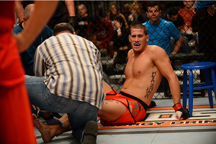 LAS VEGAS, NV - OCTOBER 16: Josh Stansbury rests on the mat after blowing out his knee during action against Chris Fields in their elimination fight during filming of season nineteen of The Ultimate Fighter on October 16, 2013 in Las Vegas, Nevada. (Phot