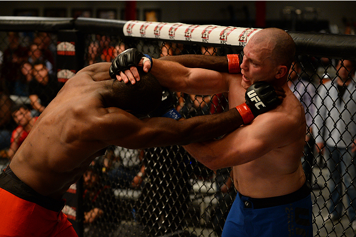 LAS VEGAS, NV - OCTOBER 16: (R-L) Kelly Anundson blocks a take down attempt by Corey Anderson in their elimination fight during filming of season nineteen of The Ultimate Fighter on October 16, 2013 in Las Vegas, Nevada. (Photo by Al Powers/Zuffa LLC/Zuf