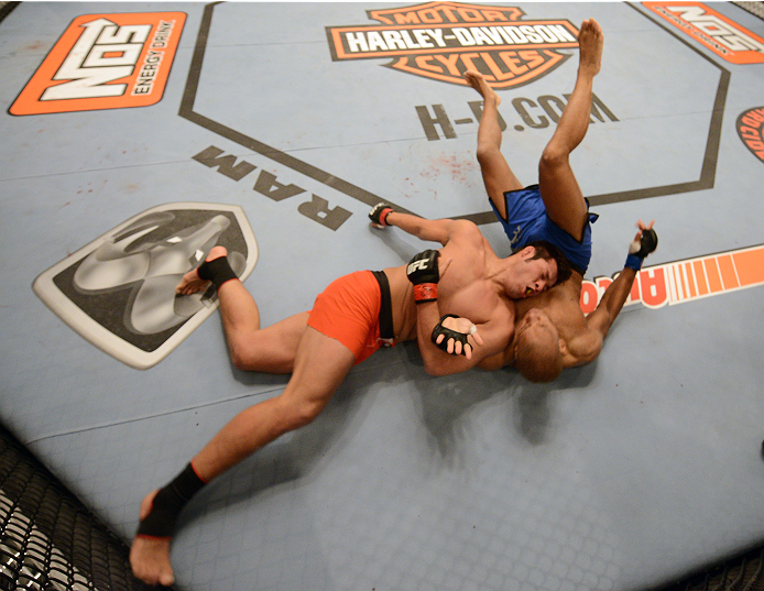 LAS VEGAS, NV - OCTOBER 16: (L-R) Hector Urbina takes down Adrian Miles in their elimination fight during filming of season nineteen of The Ultimate Fighter on October 16, 2013 in Las Vegas, Nevada. (Photo by Al Powers/Zuffa LLC/Zuffa LLC via Getty Image