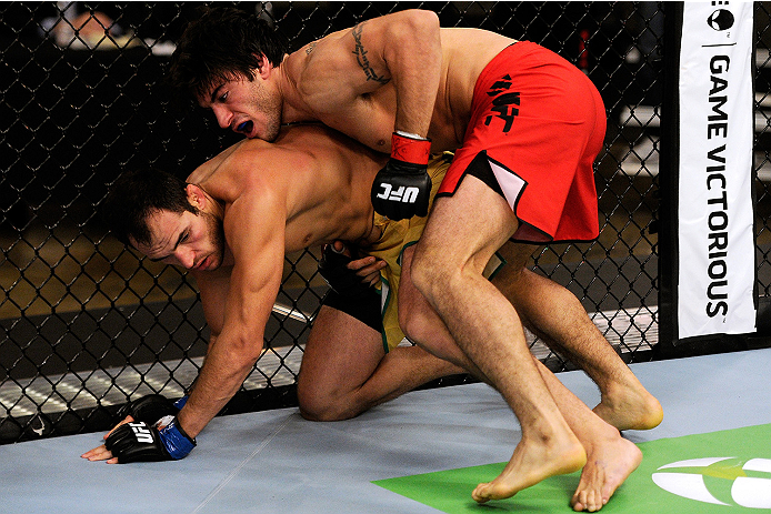 LACHUTE, CANADA - NOVEMBER 5: Team Canada fighter Elias Theodorou (red shorts) attempts a takedown against Team Australia fighter Zein Saliba in their middleweight bout during filming of The Ultimate Fighter Nations television series on November 5, 2013