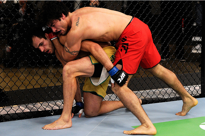 LACHUTE, CANADA - NOVEMBER 5: Team Canada fighter Elias Theodorou (red shorts) attempts a takedown against Team Australia fighter Zein Saliba in their middleweight bout during filming of The Ultimate Fighter Nations television series on November 5, 2013