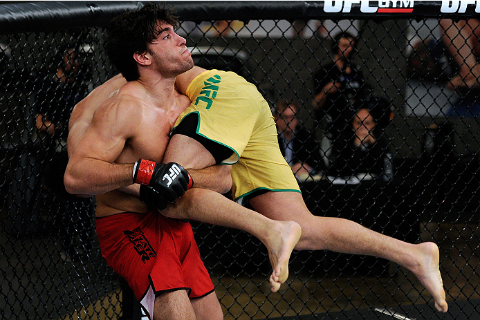 LACHUTE, CANADA - NOVEMBER 5: Team Canada fighter Elias Theodorou (red shorts) attempts a takedown against Team Australia fighter Zein Saliba in their middleweight bout during filming of The Ultimate Fighter Nations television series on November 5, 2013