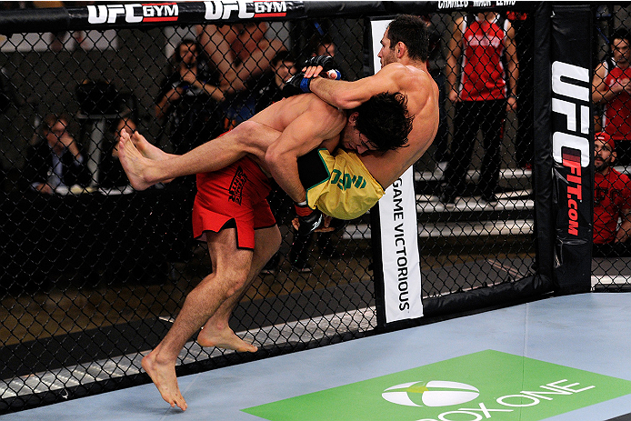 LACHUTE, CANADA - NOVEMBER 5: Team Canada fighter Elias Theodorou (red shorts) attempts a takedown against Team Australia fighter Zein Saliba in their middleweight bout during filming of The Ultimate Fighter Nations television series on November 5, 2013
