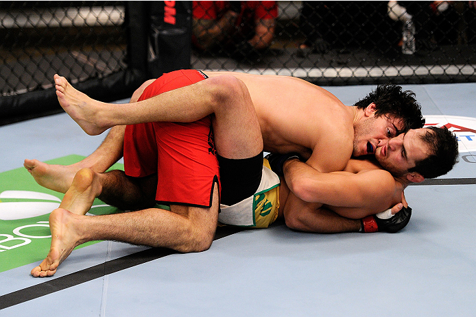LACHUTE, CANADA - NOVEMBER 5: Team Canada fighter Elias Theodorou (red shorts) takes down Team Australia fighter Zein Saliba in their middleweight bout during filming of The Ultimate Fighter Nations television series on November 5, 2013 in Lachute, Quebe