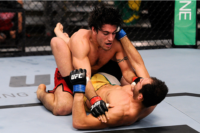 LACHUTE, CANADA - NOVEMBER 5: Team Canada fighter Elias Theodorou (red shorts) takes down Team Australia fighter Zein Saliba in their middleweight bout during filming of The Ultimate Fighter Nations television series on November 5, 2013 in Lachute, Quebe