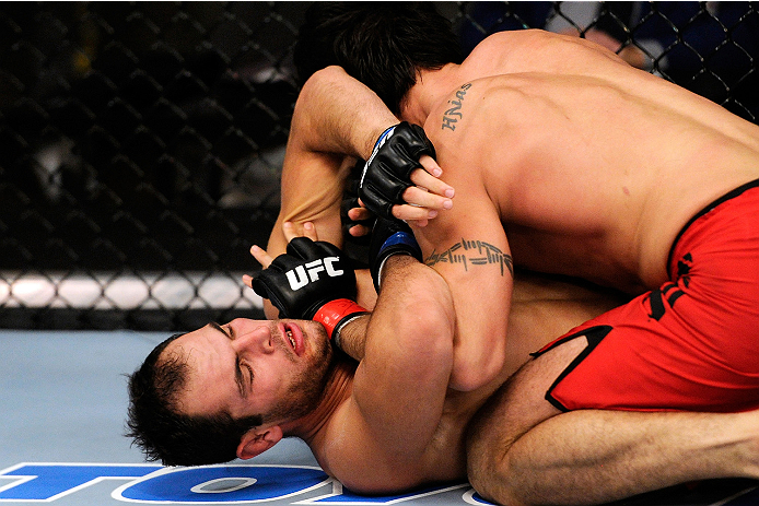LACHUTE, CANADA - NOVEMBER 5: Team Canada fighter Elias Theodorou (red shorts) takes down Team Australia fighter Zein Saliba in their middleweight bout during filming of The Ultimate Fighter Nations television series on November 5, 2013 in Lachute, Quebe