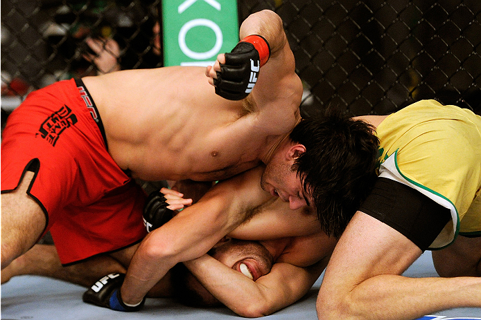 LACHUTE, CANADA - NOVEMBER 5: Team Canada fighter Elias Theodorou (red shorts) punches Team Australia fighter Zein Saliba in their middleweight bout during filming of The Ultimate Fighter Nations television series on November 5, 2013 in Lachute, Quebec,