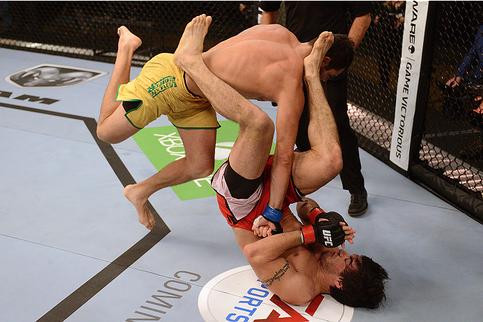 LACHUTE, CANADA - NOVEMBER 5: (L-R) Team Australia fighter Zein Saliba throws a flying punch at Team Canada fighter Elias Theodorou in their middleweight bout during filming of The Ultimate Fighter Nations television series on November 5, 2013 in Lachute