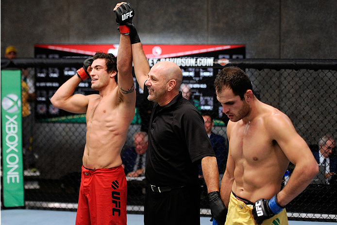 LACHUTE, CANADA - NOVEMBER 5: (L-R) Team Canada fighter Elias Theodorou is declared the winner by referee Yves Lavigne after his middleweight bout against Team Australia fighter Zein Saliba during filming of The Ultimate Fighter Nations television serie
