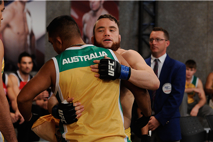 LACHUTE, CANADA - NOVEMBER 2: Team Australia fighter Brendan O'Reilly hugs a teammate before entering the Octagon to take on Team Canada fighter Kajan Johnson in their welterweight bout during filming of The Ultimate Fighter Nations television series on